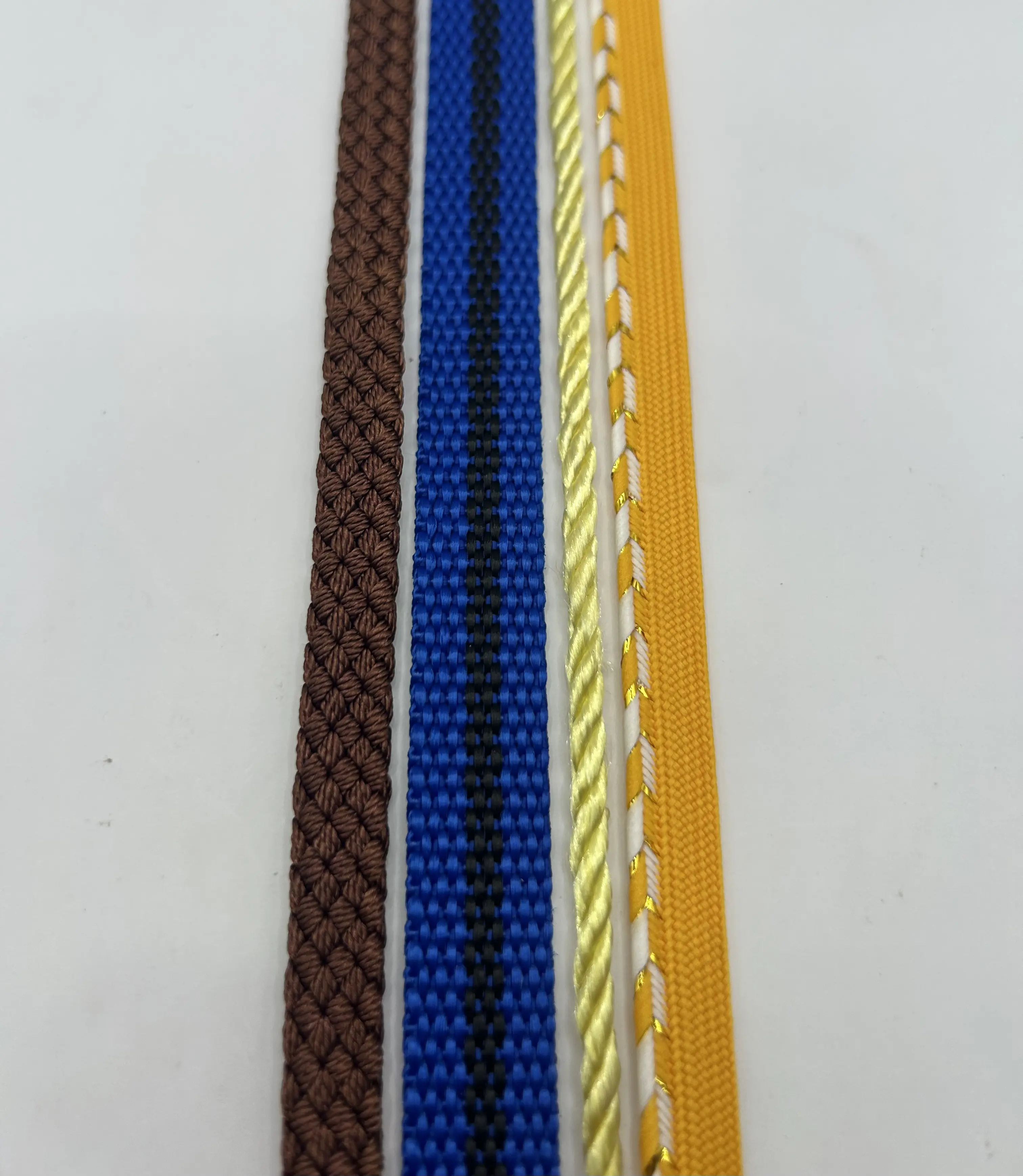 From left to right: braided webbing, high-speed webbing, twisted cord, and two-tone webbing
